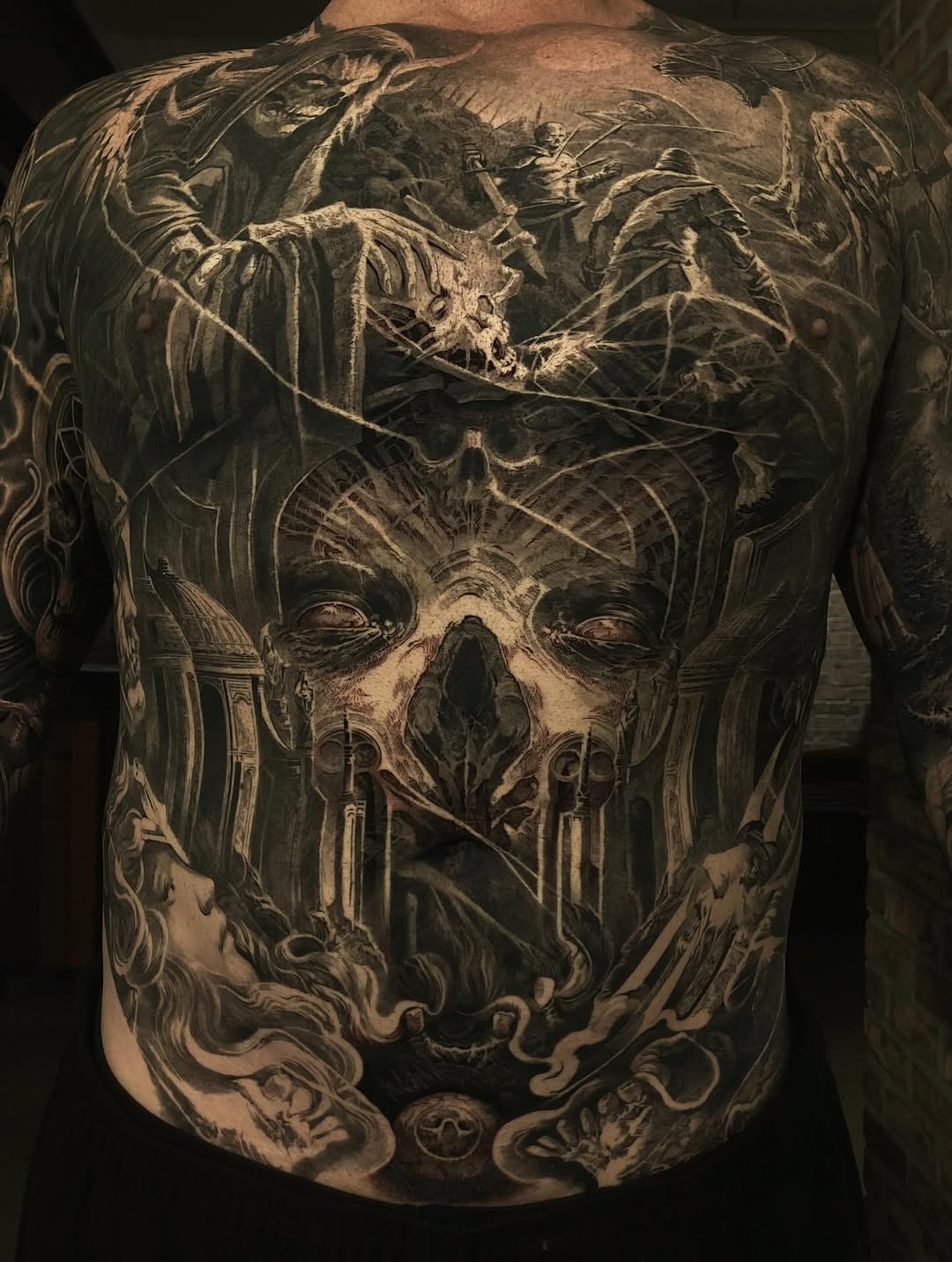 Skull and skeletal figures back-piece in black-and-grey