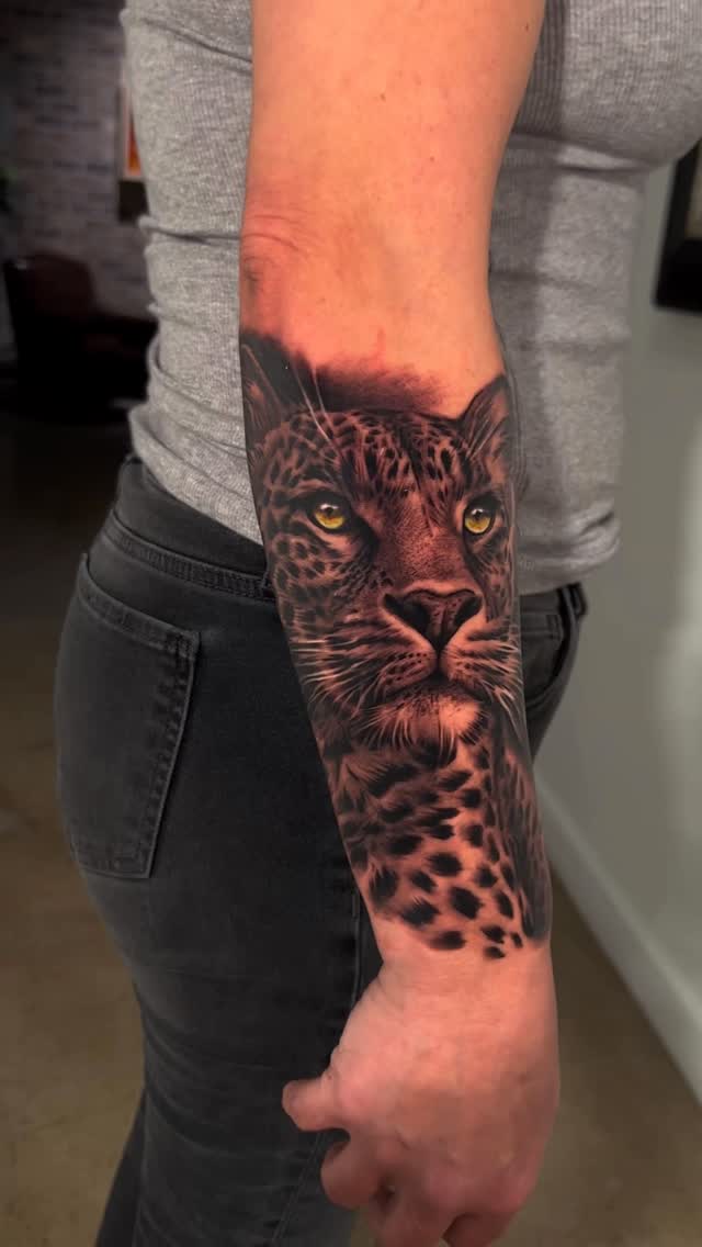 Leopard portrait forearm tattoo in color