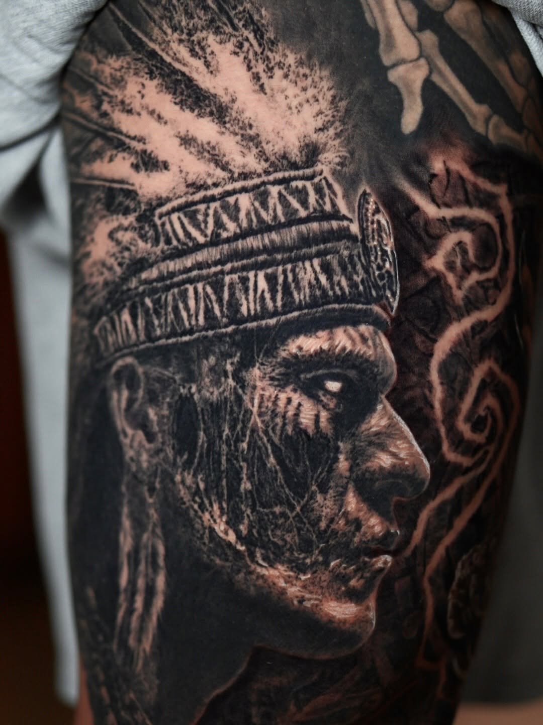 Aztec warrior portrait with headdress, thigh