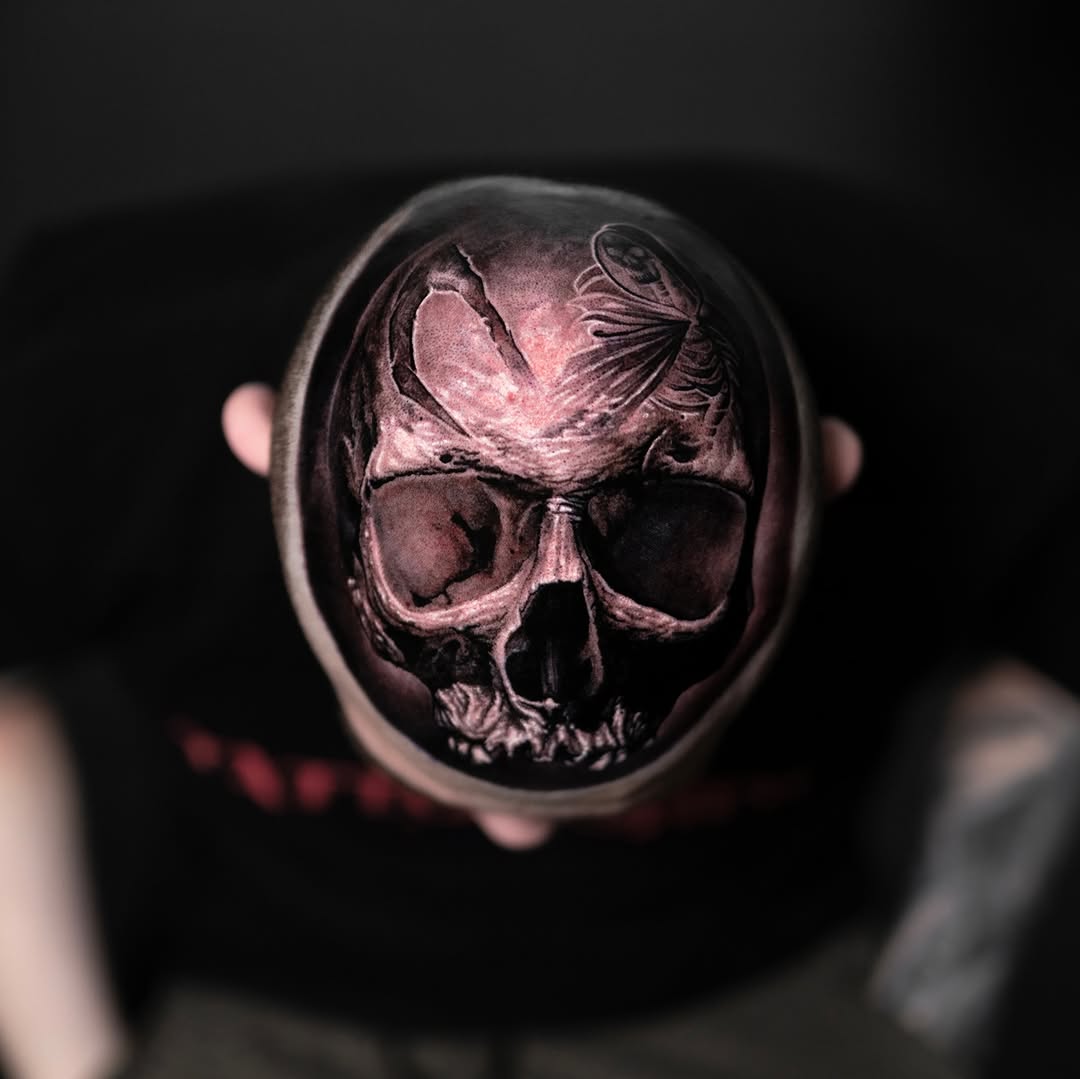 Detailed skull ring tattoo with nested skull design
