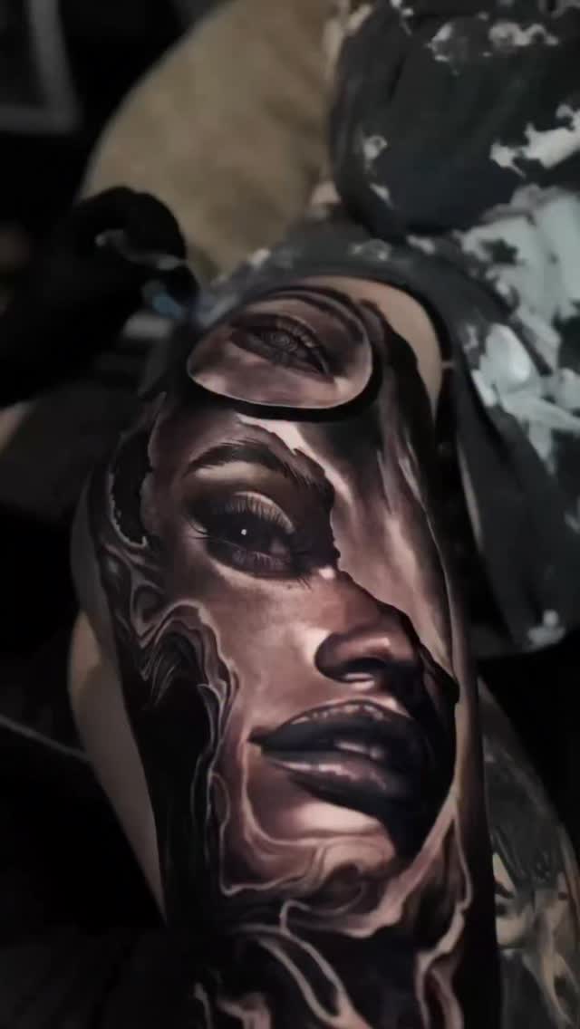 Black-and-grey portrait tattoo, outer leg