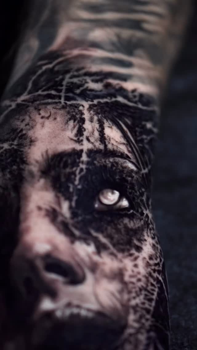 Detailed hand portrait tattoo, black-and-grey realism
