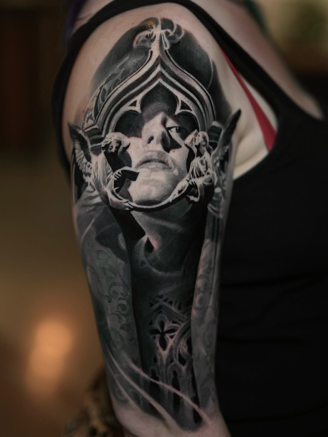 Black-and-grey portrait with ornamental frame, shoulder
