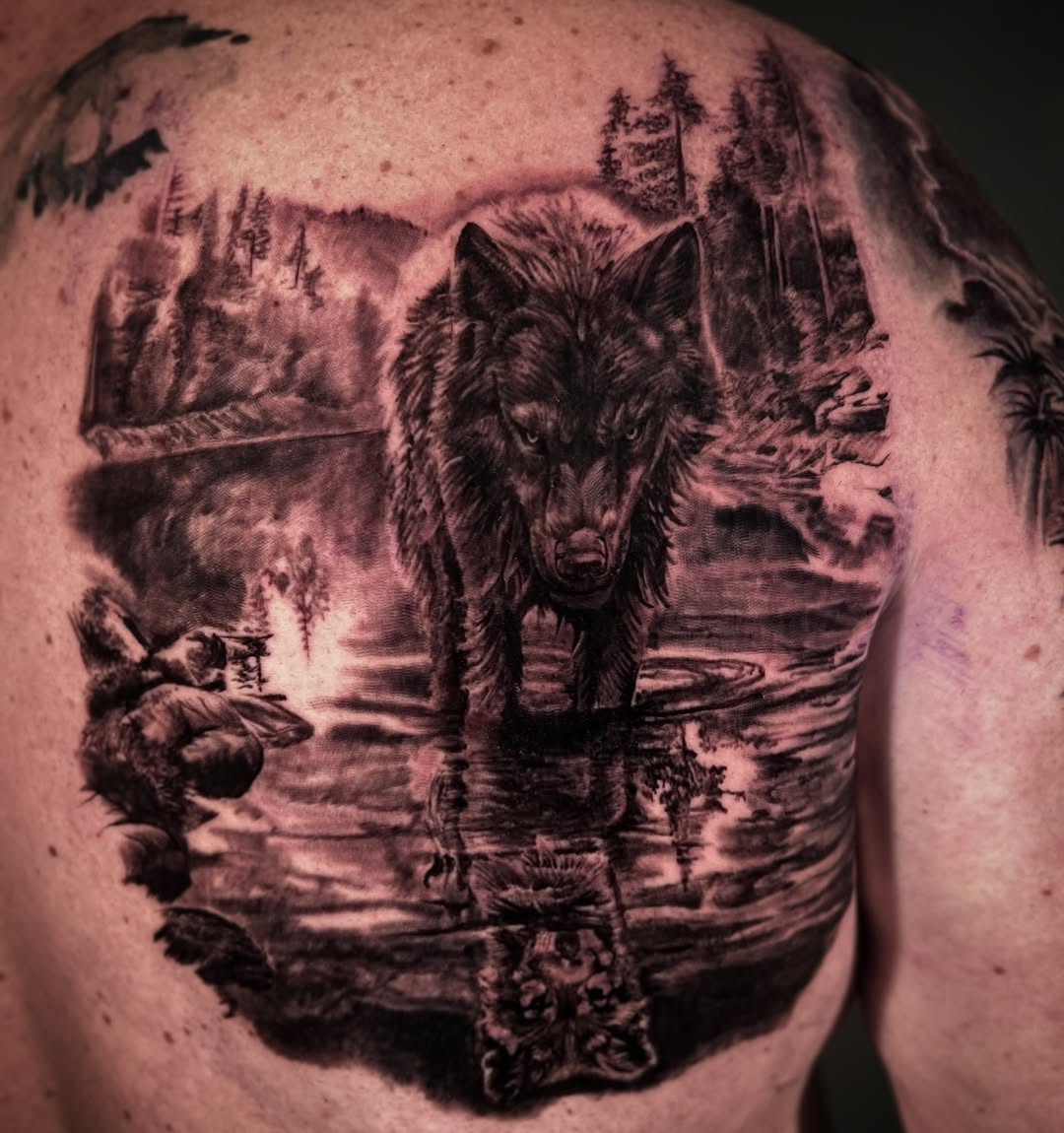 Black-and-grey wolf in forest landscape, back piece