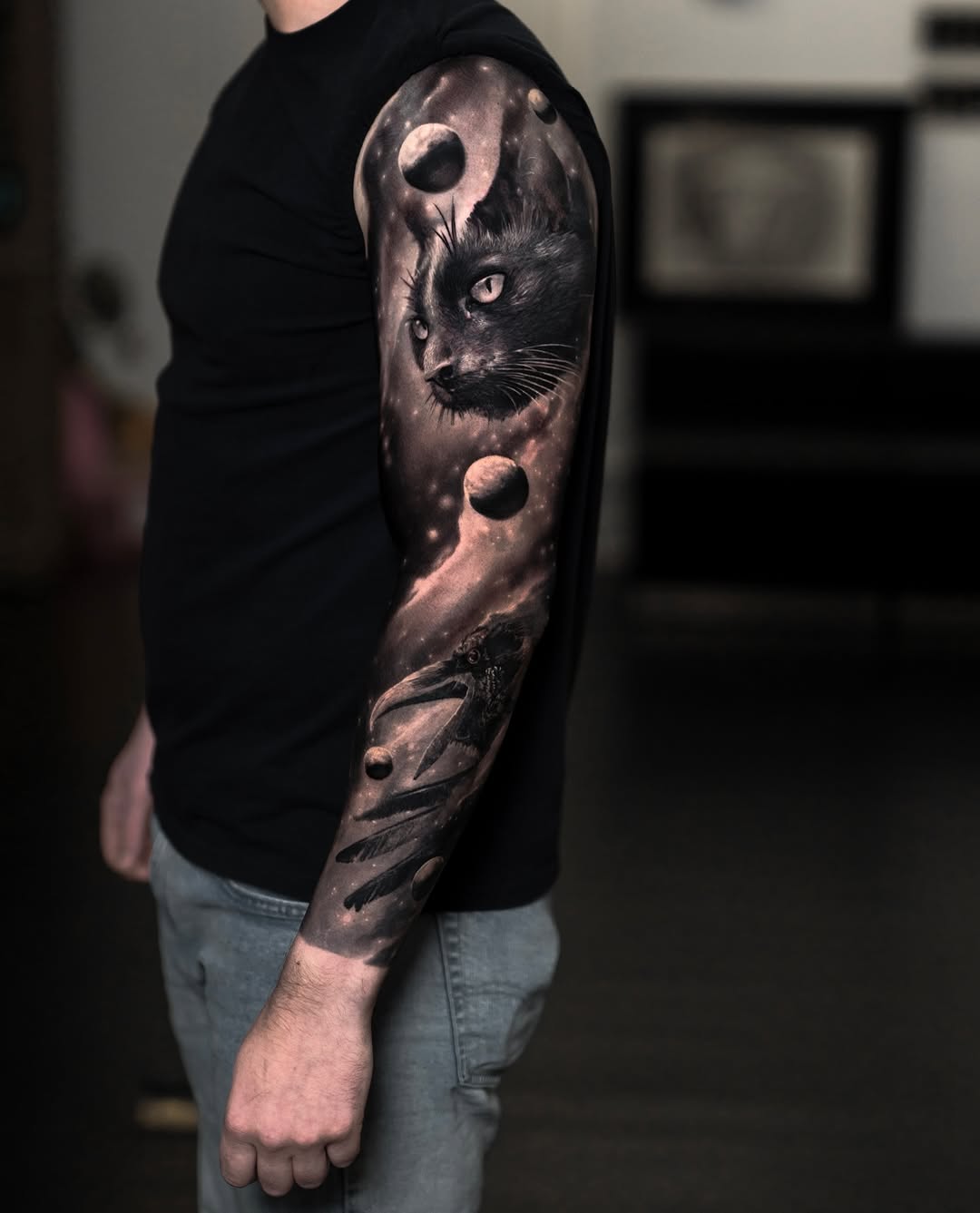Black-and-grey cosmic cat sleeve with celestial elements