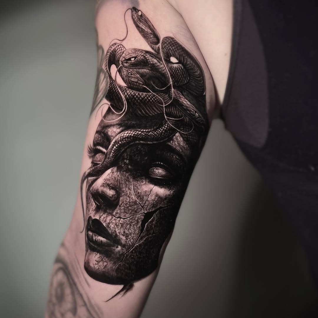 Black-and-grey Medusa portrait with snake texture, thigh