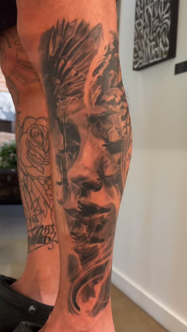 Black-and-grey portrait with winged angel, leg sleeve