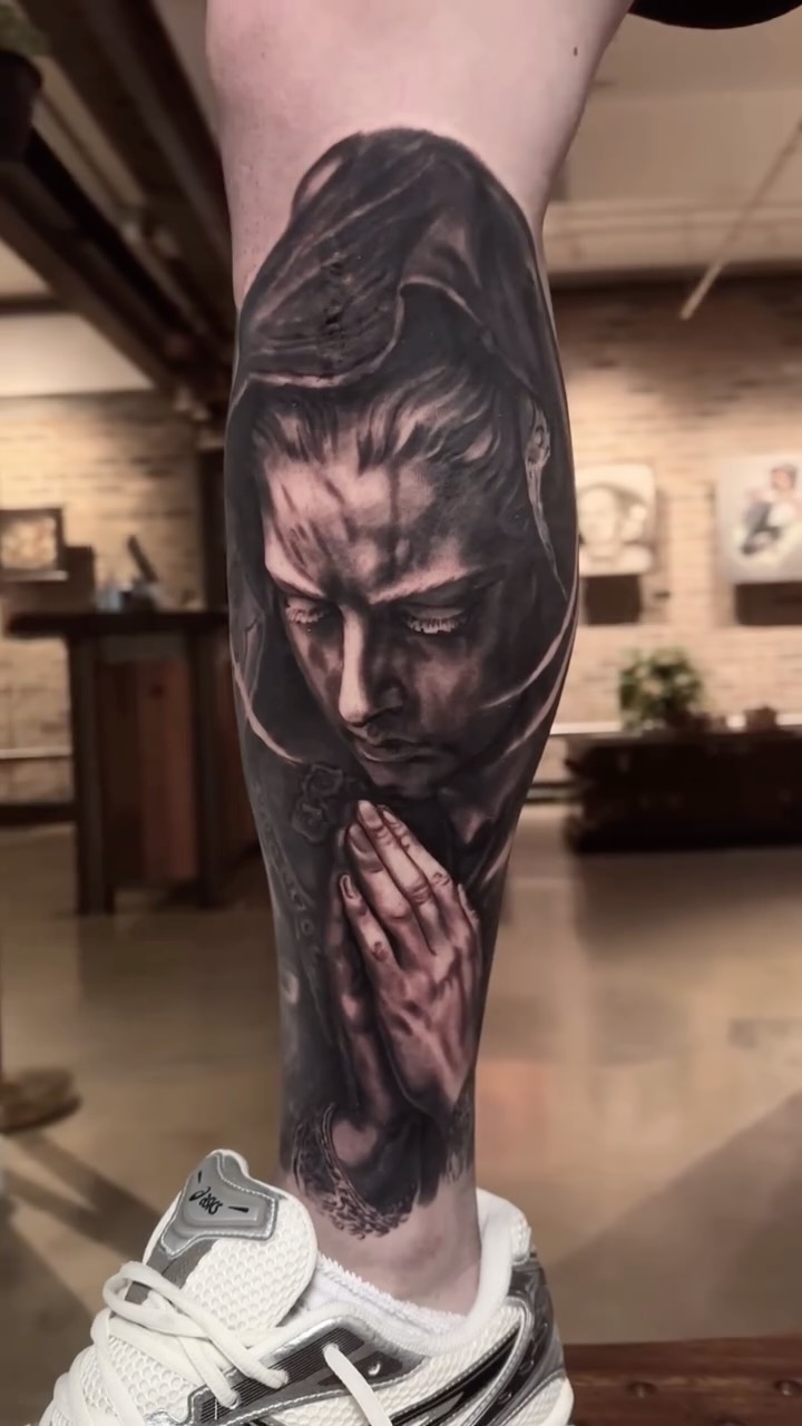 Black-and-grey portrait leg sleeve in progress
