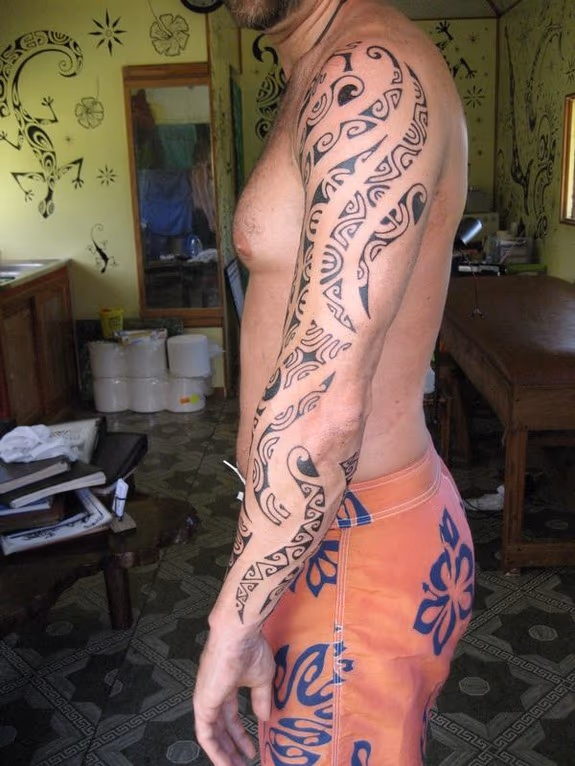 Black work arm tattoo