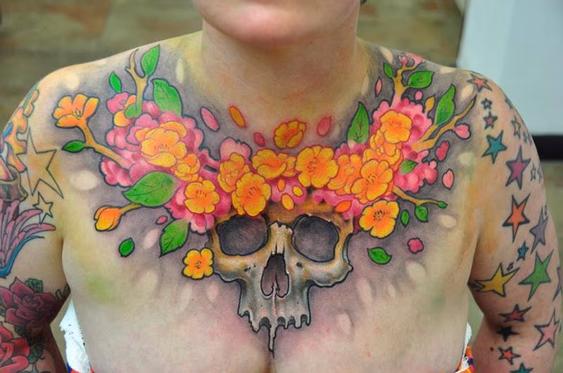 Skull and flowers chest tattoo