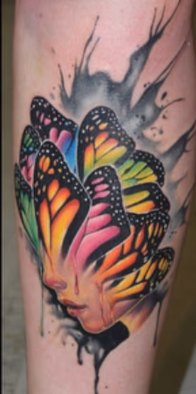 Butterfly face tattoo