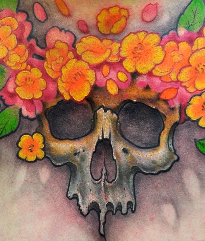 Skull and flowers chest tattoo detail