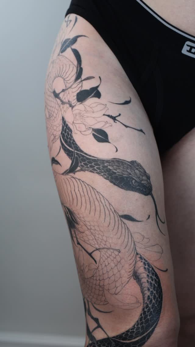 Black-and-grey snake and floral leg sleeve