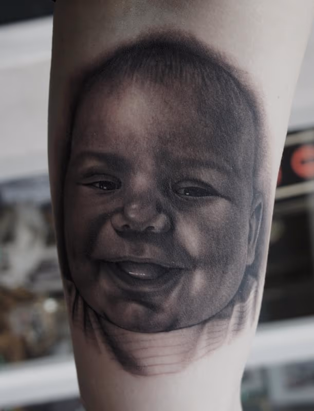 Black and Gray Baby Portrait Tattoo