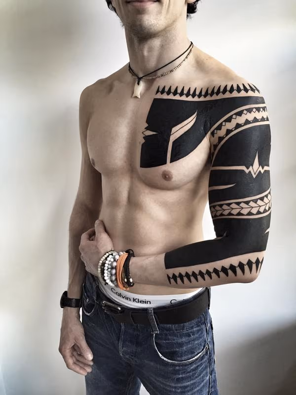 Blackwork Patterned Chest Bicep Tattoo