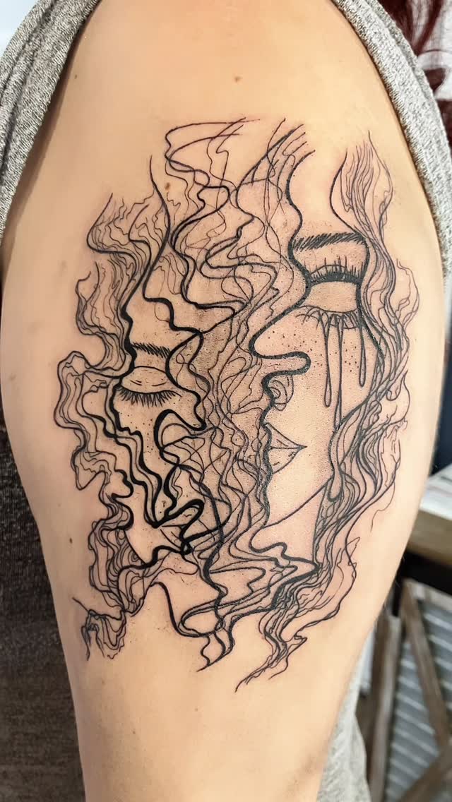 Abstract surreal face with flowing lines, upper arm