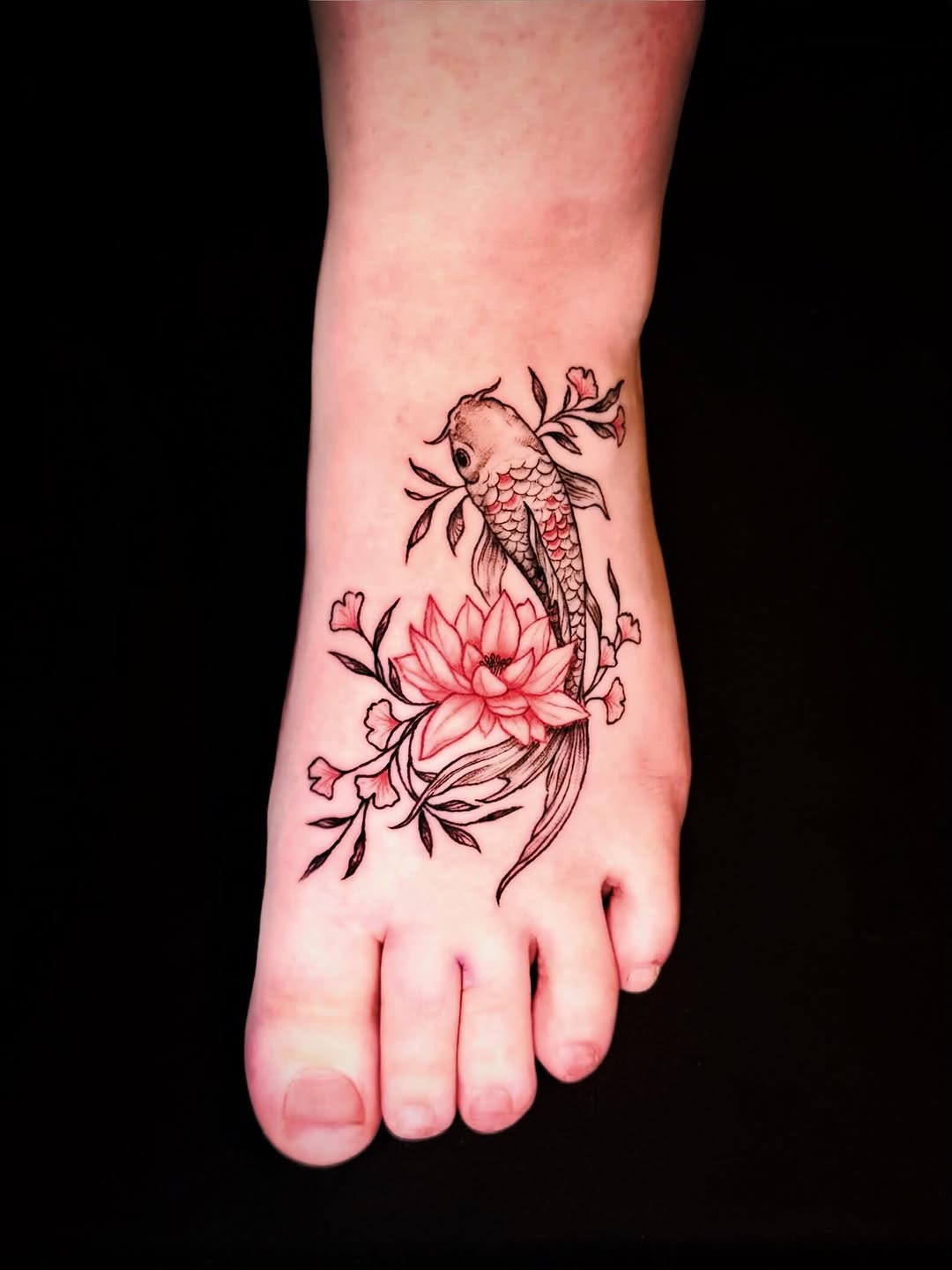 Koi and lotus flower foot tattoo