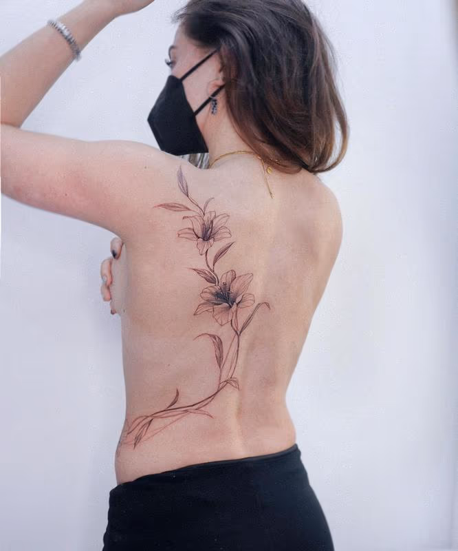 Flowering flowers back tattoo