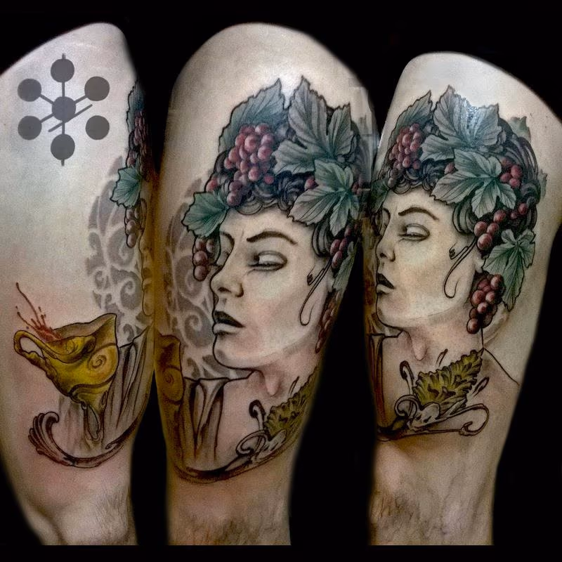 Androgynous Greek Wine grapes Art Nouveau leg tattoo by Yorick Tattoo